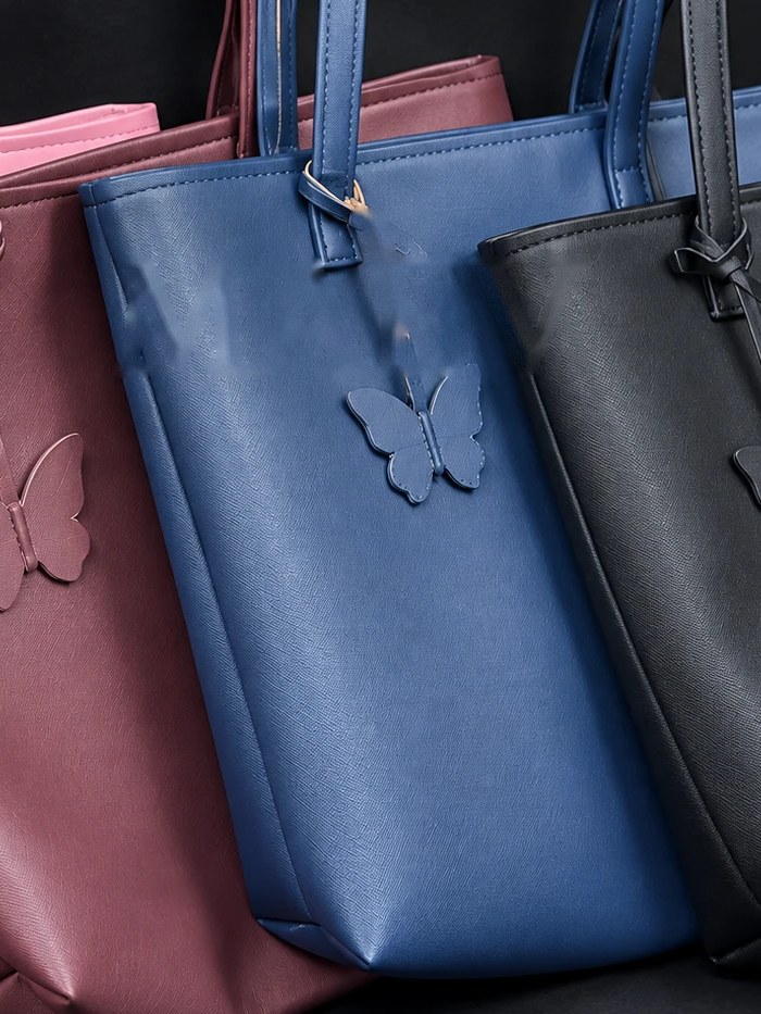 MAEV tote in Dusk, a deep blue with a butterfly charm